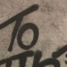 graffiti written in black on concrete with the number ten below it