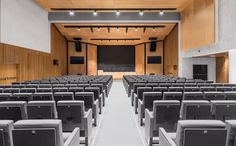 an empty lecture hall with rows of seats