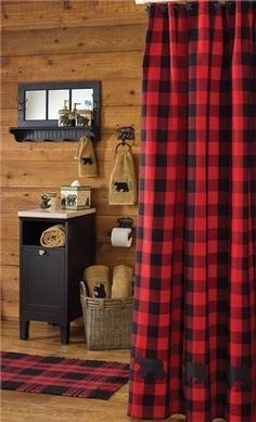 a red and black plaid shower curtain in a bathroom with wood paneling on the walls