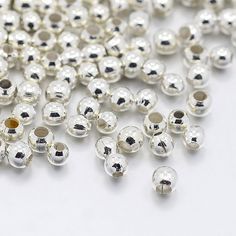 many silver colored beads on a white surface