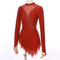 a woman's red dress with sequins on the neckline and long sleeves