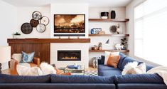 a living room filled with furniture and a fire place in the middle of the room