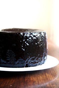 a chocolate cake sitting on top of a white plate