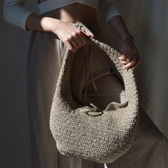 Elevate your summer style with this chic Raffia Crochet Hobo Bag. Handcrafted from 100% natural raffia, this vegan shoulder bag perfectly balances elegance and functionality. Its spacious interior makes it ideal for carrying all your essentials, whether you're heading to the beach or going for a casual outing. The comfortable strap ensures that you can carry it effortlessly, making it a versatile accessory for any occasion. Available in four stunning colors--gray, beige, burgundy, and black--thi Crochet Hobo Bag, Raffia Crochet, Bohemian Minimalist, Beach Gifts, Raffia Bag, Eco Friendly Fashion, Timeless Accessories, Bag Handmade, Boho Stil