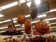 halloween decorations hanging from the ceiling in a store