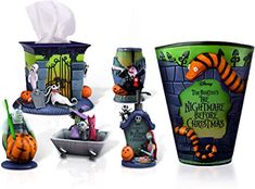 three halloween themed cups and napkin holders on a white surface, one is decorated with cartoon characters