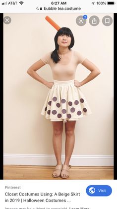 a woman standing in front of a wall with a bat on top of her head