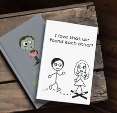 two notebooks sitting on top of a wooden table next to each other with cartoon characters