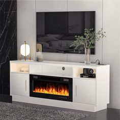 a white entertainment center with a fire place