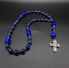 The Deep Blue Irish Anglican Rosary is a beautiful rosary that radiates the seven seas and provides you with a calming effect while praying. The rosary is made of Swarovski Crystals, Lapis lazuli and Jade gemstones (which have been cleansed and purified) while a Stainless Silver Cross completes the rosary. Finally, the rosary has been blessed by the church. Rosary: Anglican configuration Blessed: Yes About the Rosary: The Rosary has a Cross, an Invitatory bead, 4 sets of 7 beads that are called Anglican Rosary, Praying The Rosary, Rosary Necklace, Unique Handmade Jewelry, Lava Stone, Jade Beads, Silver Cross, The Deep, Pure Silver