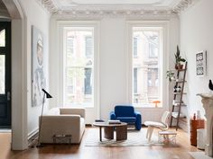 a living room filled with furniture and windows