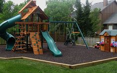 a wooden play set with swings and slides