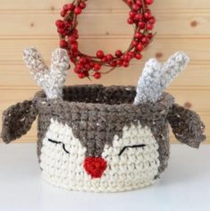 a crocheted basket with a reindeer face on it