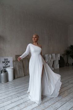 a woman in a white dress posing for the camera