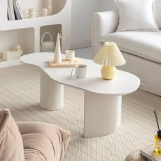 a living room with a white couch and coffee table in it's center area