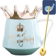 a tea pot with a gold spoon in front of it and the words queen of everything on it