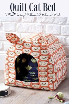 a cat bed made out of an orange and white pattern