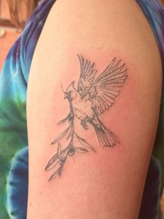 a small bird tattoo on the right arm