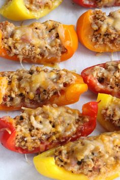 several stuffed peppers with cheese on them