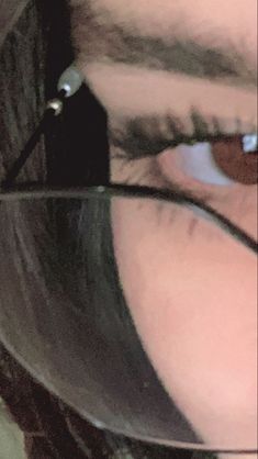 a close up of a person's eye with glasses on