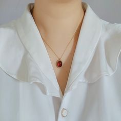 This  carnelian pendant necklace, red necklace, red pendant on a 18k chain, stainless steel, tarnish resistant, vintage style, red carnelian looks so elegant and cute. It is made with 18k (vacuum-plated on stainless steel) 1.3mm chain and an oval shaped vintage style carnelian pendant. The carnelian stone is approximately 6×8 mm.  The carnelian stone is red/orange in nature. Under the sunlight, it may appear a little transparent. Carnelian is believed to be the stone of courage and motivation. I Dainty Red Round Pendant Necklace, Vintage Red Garnet Necklace, Red Round Pendant Charm Necklace, Vintage Red Gemstone Necklace, Red Garnet Oval Pendant Necklace, Red Tarnish-resistant Pendant Jewelry, Red Garnet Pendant Necklace, Red Carnelian Oval Pendant Necklaces, Red Carnelian Oval Pendant Necklace