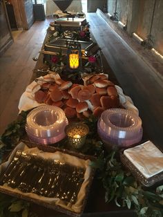 the buffet table is full of food and candles