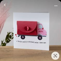 a card with a pink truck on the front and red envelope in the back that says, i love you more than i love you