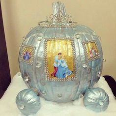 a blue pumpkin decorated with pictures and pearls