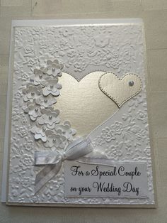 a wedding card with a heart and ribbon on the front that says for a special couple on your wedding day