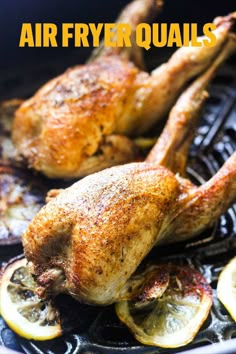 the chicken is being cooked on the grill with lemons and other ingredients around it