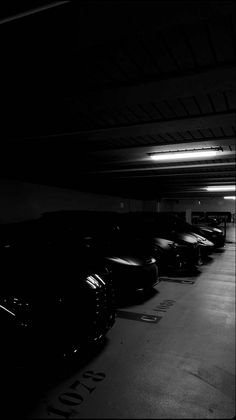 a parking garage with several cars parked in it