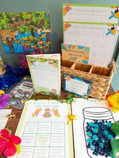 the table is set up with many items for children's learning to read and write