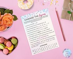 a pink table topped with donuts and doughnut holes next to a paper that says change the day