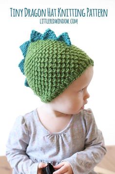 a baby wearing a green knitted hat with bows on it's head and text overlay that says, tiny dragon hat knitting pattern