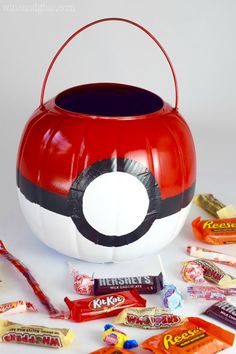 a pokeball candy bucket filled with assorted candy