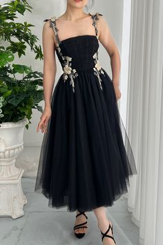 This luxe black midi dress is the perfect combination of elegance and sensuality. Designed with an exquisite corset top and a flirty tulle skirt, this ensemble exudes the effortless grace of an iconic fashion piece. Its strapless design makes it a timeless classic fit for stylish night events. Bust and Skirt with full lining. 100% Polyester 100% Recycled polyester lining Concealed zip at center back Imported Patterned Bridesmaid, Tulle Midi Dress, Iconic Fashion, Black Tulle, Black Midi, Classic Chic, Tulle Fabric, Prom Party, Tea Length