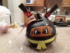 a kitchen counter top with a pumpkin shaped like a ninja