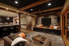 a living room filled with furniture and a flat screen tv on top of a wall