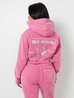 Shop the Matching Sweat Pant  Lounge out in style with the Acid Wash V Notch Hoodie. Crafted from fleece-lined fabrication, this cropped hoodie features a V-notch neckline, chest horseshoe logo, dropped long sleeves, and a hood. Finished with contrasting top stitching and a back Buddha logo.  Style: 208590C Luxury Hoodie Women, Pink True Religion Hoodie, True Religion Set, True Religion Tracksuit, True Religion Sweatsuit, Pink Sweat Suit, Pink Graphic Hoodie, Christmas List Items, Pink True Religion