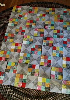 a patchwork quilt is laying on the floor