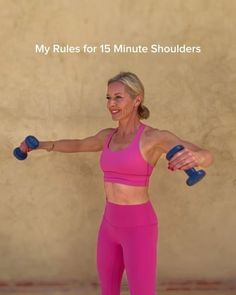 a woman holding two blue dumbs while standing next to a wall with the words, my rules for 15 minute shoulders