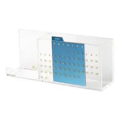 a clear desk calendar with blue numbers on the front and back sides, in a display case