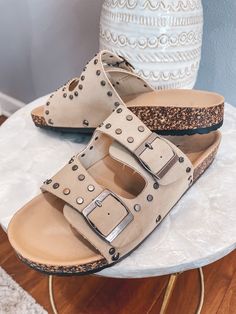 True to size - Trendy and comfortable are the best words to describe the Tilly Slide Sandals! With two buckle straps and rivet details throughout, you’ll be reaching for these sandals all summer long! Trendy Studded Open Toe Sandals, Trendy Open Toe Sandals With Studs, Casual Sandals With Rivets And Round Toe, Trendy Adjustable Buckle Footbed Sandals, Trendy Summer Sandals With Rivets, Spring Open Toe Sandals With Rivets, Spring Rivets Open Toe Sandals, Casual Rivets Sandals For Spring, Casual Summer Sandals With Rivets