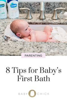 a baby laying in a bathroom sink with the title 8 tips for baby's first bath