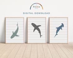 three framed pictures with shark silhouettes on them in front of a white wall and wooden floor