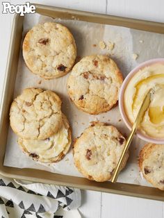 cookies and butter on a baking sheet with a spoon