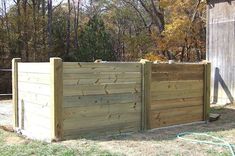 a wooden fence in the middle of a yard