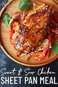 sweet and sour chicken sheet pan meal on a wooden plate with mint garnish