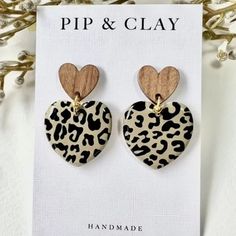 the leopard print heart shaped earrings are made from wood and have wooden hearts on them