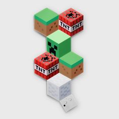 an image of three different colored blocks with the word tht on them and two dices